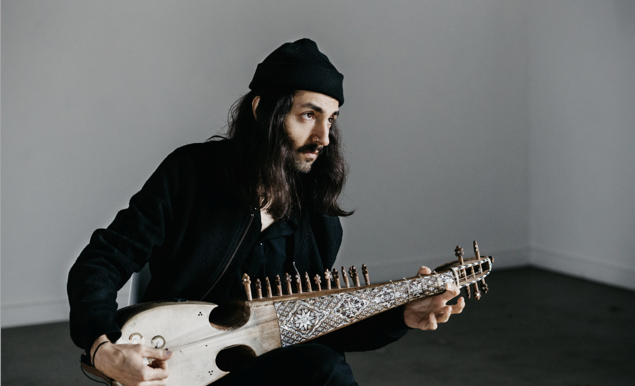 Qais Essar poses with his rabab